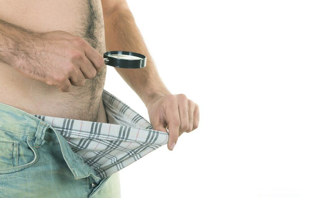 man looking at penis size